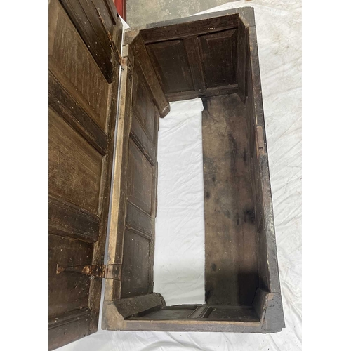 579 - An 18th century or earlier oak coffer, four panel top opening to storage, three carved panel front, ... 