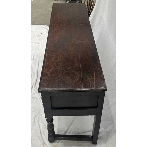 580 - A Jacobean oak dresser base or sideboard, two plank top above three deep drawers each with a central... 