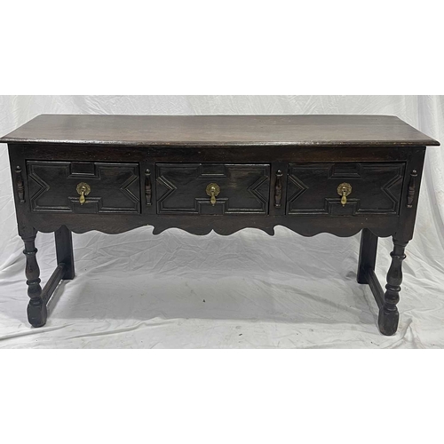 580 - A Jacobean oak dresser base or sideboard, two plank top above three deep drawers each with a central... 