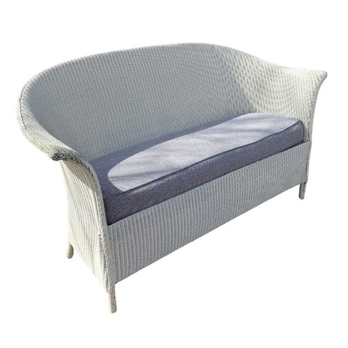 584 - A Lloyd Loom of Spalding white painted sofa, with loose fitted cushion in a blue an white fabric, he... 