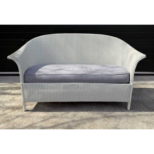 584 - A Lloyd Loom of Spalding white painted sofa, with loose fitted cushion in a blue an white fabric, he... 