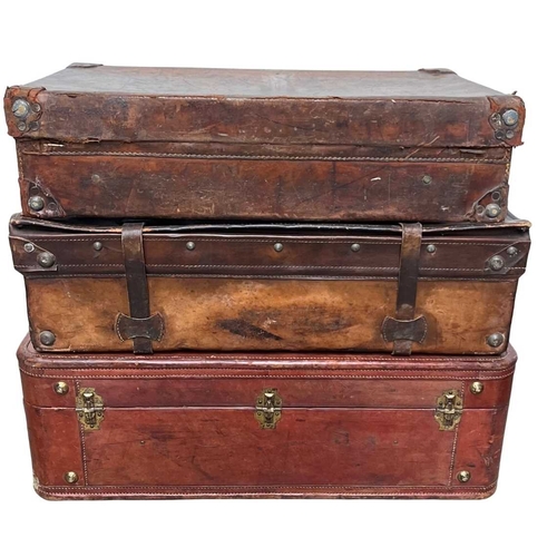 586 - A large brown leather suitcase, brassed fittings and studs for feet, brown silk interior, height app... 
