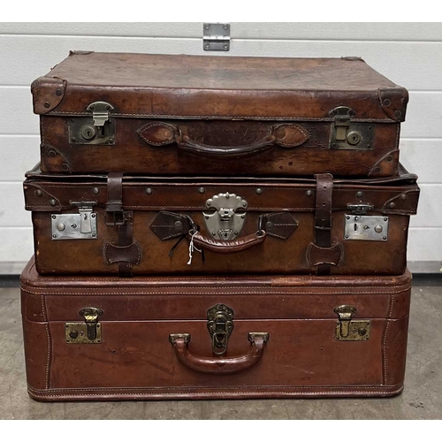 586 - A large brown leather suitcase, brassed fittings and studs for feet, brown silk interior, height app... 