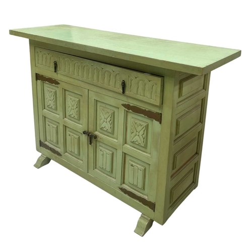589 - A green painted chest of drawers, five drawers loosely in a Spanish style, brass pulls, distressed f... 