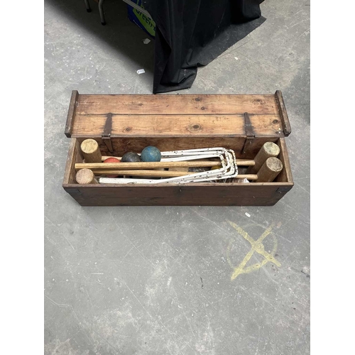 590 - An early 20th century croquet set, containing mallets, balls, hoops, a net etc, boxed, height 26cm, ... 