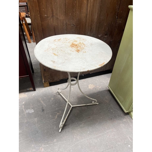 591 - A white-painted metal, garden or orangery, table, round top to three wrought legs supported by a tri... 