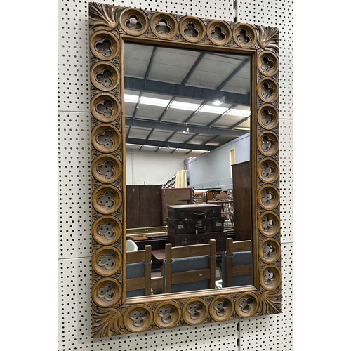 594 - A carved beech-framed wall mirror, the frame with cut-out trefoil shapes in roundels, height 88.5cm,... 
