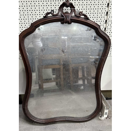 594 - A carved beech-framed wall mirror, the frame with cut-out trefoil shapes in roundels, height 88.5cm,... 