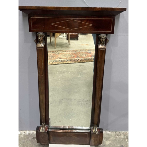 595 - A mahogany Empire design pier glass, 19th Century, probably French, cornice above panel with metal i... 