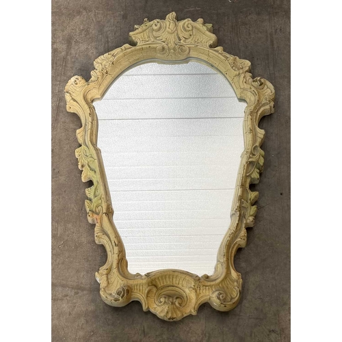 600 - A painted wooden wall mirror, bombe form with asymmetric rococo carving to the top, bevelled glass p... 