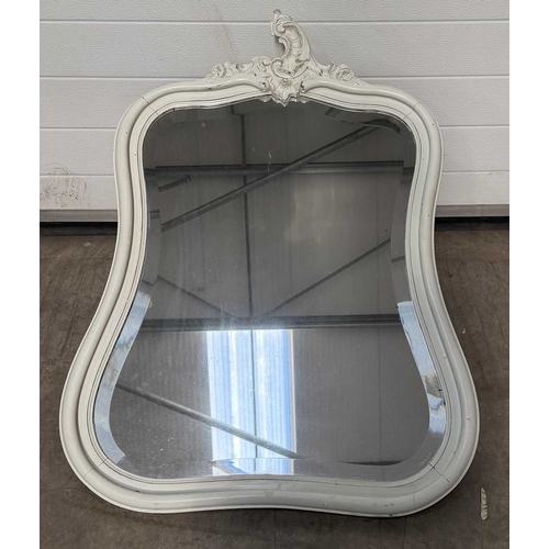 600 - A painted wooden wall mirror, bombe form with asymmetric rococo carving to the top, bevelled glass p... 