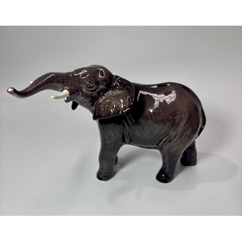81 - A Beswick ceramic lion, height approx 13.5cm, together with a lioness, height 14cm and an elephant (... 