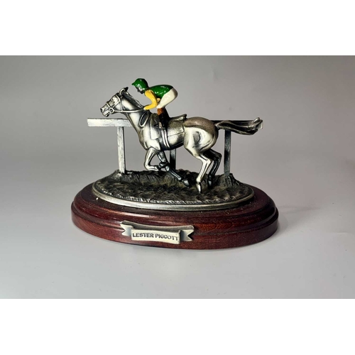 84 - A small group of hand painted, cast metal figurines of jockeys racing horses, mounted to wooden plin... 