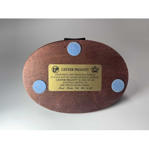 84 - A small group of hand painted, cast metal figurines of jockeys racing horses, mounted to wooden plin... 