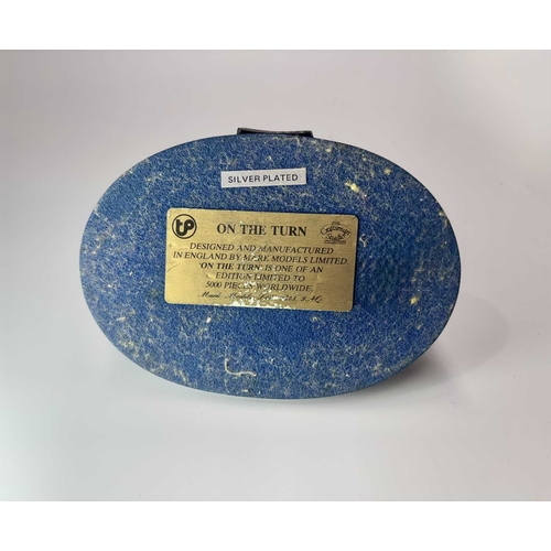 84 - A small group of hand painted, cast metal figurines of jockeys racing horses, mounted to wooden plin... 