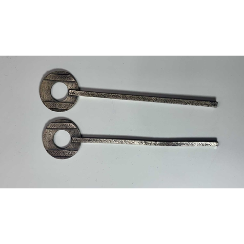 84 - A small group of hand painted, cast metal figurines of jockeys racing horses, mounted to wooden plin... 