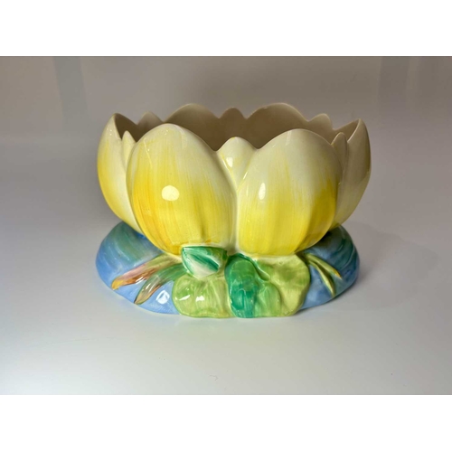 90 - Clarice Cliff for Newport Pottery, a Waterlily moulded bowl, painted yellow, printed marks, 22.5cm l... 