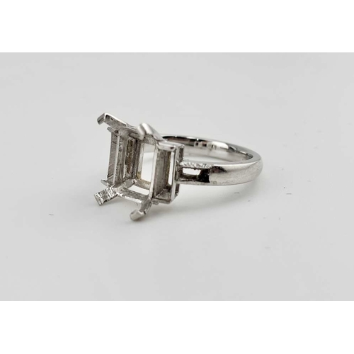 415 - A platinum ring mount, designed for a central rectangular-shape stone flanked by baguette settings a... 