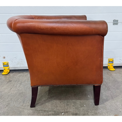 547 - A Laura Ashley 'Osbourne' brown tan leather, tub armchair in a club style with brass studding, legs ... 