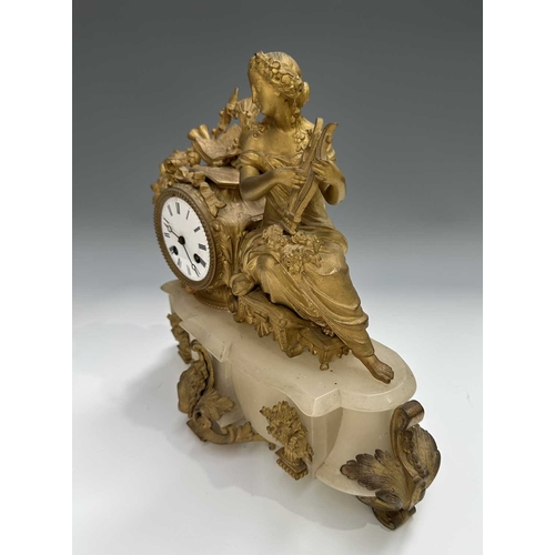 272 - A French mantle clock, 19th century, alabaster base surmounted with a finely cast and gilded female ... 