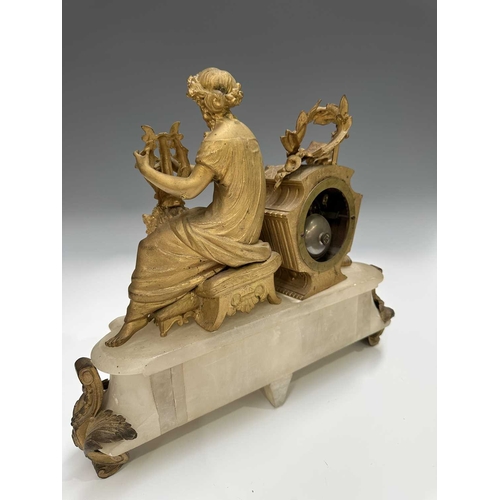 272 - A French mantle clock, 19th century, alabaster base surmounted with a finely cast and gilded female ... 