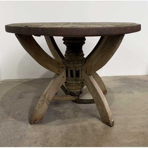 672 - An oak garden table assembled with wooden wheel components, consisting of a circular wooden wheel to... 