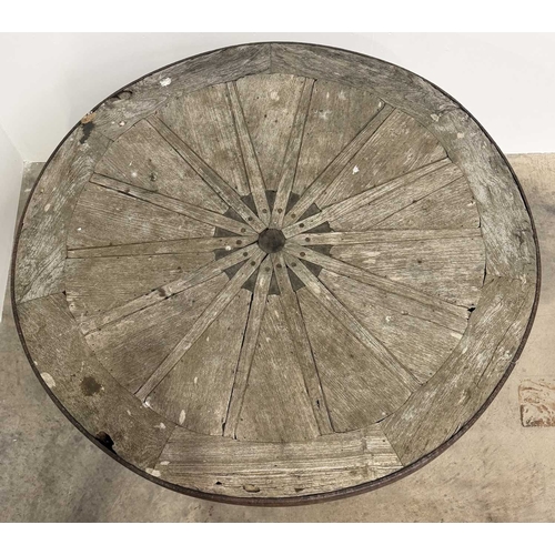 672 - An oak garden table assembled with wooden wheel components, consisting of a circular wooden wheel to... 