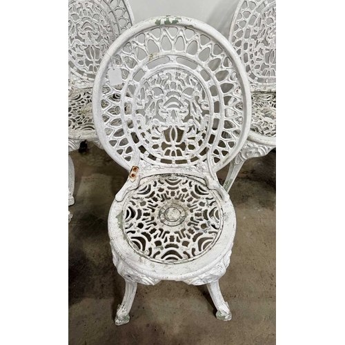 673 - Cast metal bistrot table and four chairs in the Victorian style with cast fretwork pattern, h: 70.5c... 