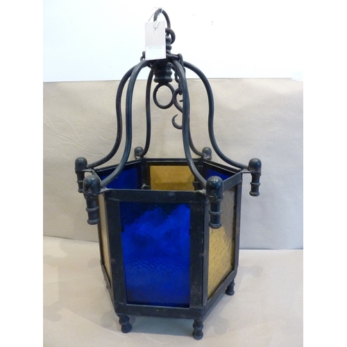 121 - A large and heavy Arts and Crafts style hexagonal iron and leaded glass sided ceiling hanging lanter... 