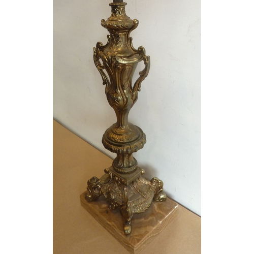 134 - A heavy gilt-metal table-lamp and shade upon a rectangular brown marble base