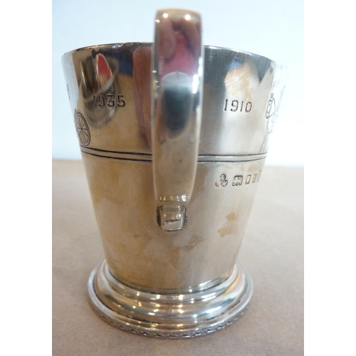 155 - A 19th century hallmarked silver caster in the 17th century style together with a 1935 Royal Commemo... 