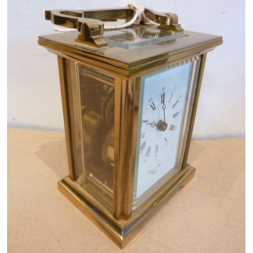 258 - A 19th century style (modern) gilt-metal and glass-sided carriage clock; the white enamel dial with ... 