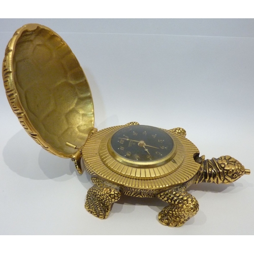 300 - A good quality brass bedside clock contained within a gilded metal  case modelled as a tortoise