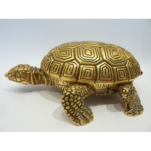 300 - A good quality brass bedside clock contained within a gilded metal  case modelled as a tortoise