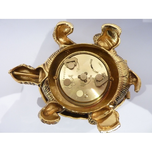 300 - A good quality brass bedside clock contained within a gilded metal  case modelled as a tortoise