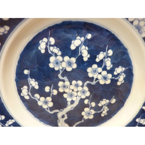 35 - A Chinese blue-and-white dish with prunus decoration and six-character mark to the base; together wi... 