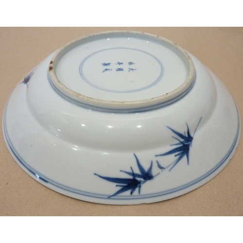 35 - A Chinese blue-and-white dish with prunus decoration and six-character mark to the base; together wi... 