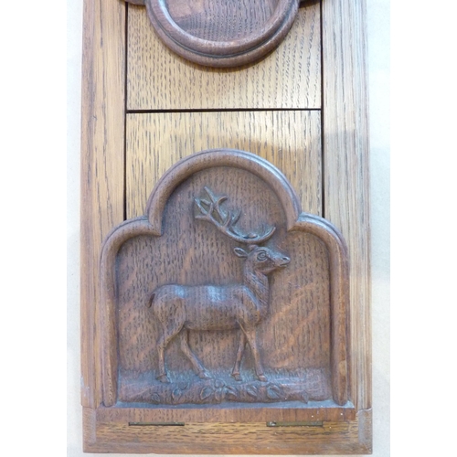 356 - An early 20th century oak book slide; the two adjustable ends carved in relief with goats and a stag