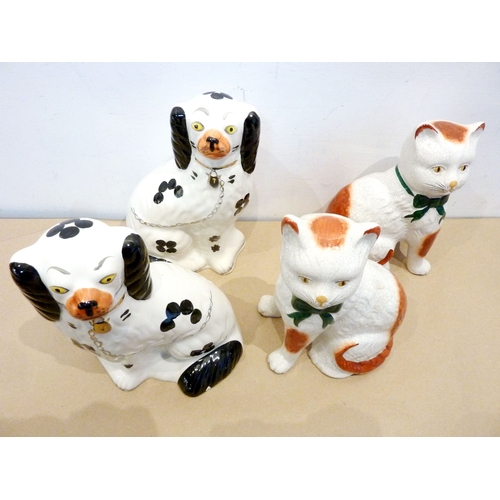 70 - A pair of fireside dogs together with a pair of Staffordshire fireside cats