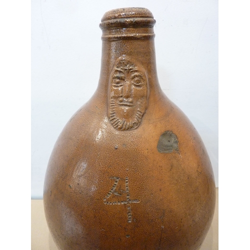 78 - A large old stoneware jug with the face of Cardinal Bellarmine to the neck