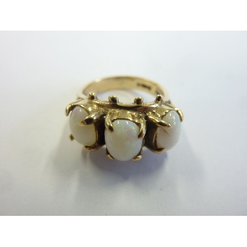 175 - A 9-carat gold boathead-style ring set with three large opals