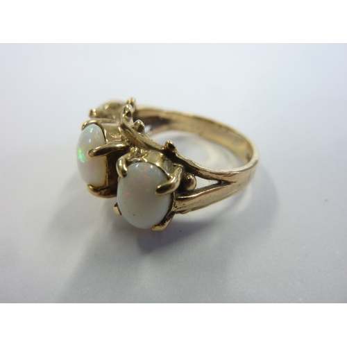 175 - A 9-carat gold boathead-style ring set with three large opals