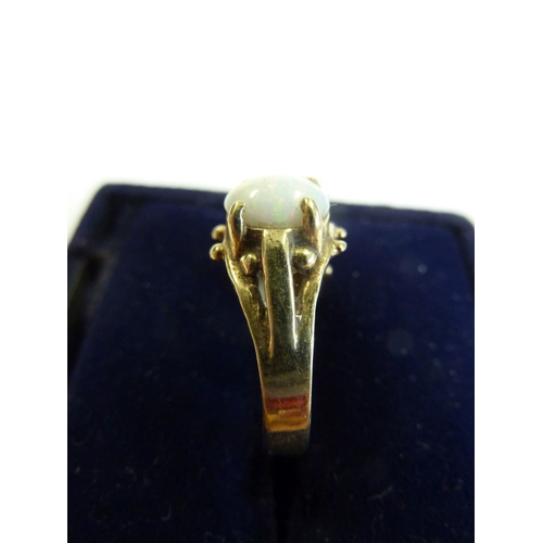 175 - A 9-carat gold boathead-style ring set with three large opals