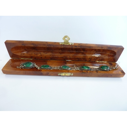 193 - A silver bracelet set with oval cabouchon malachite stones within a burr-wood presentation case