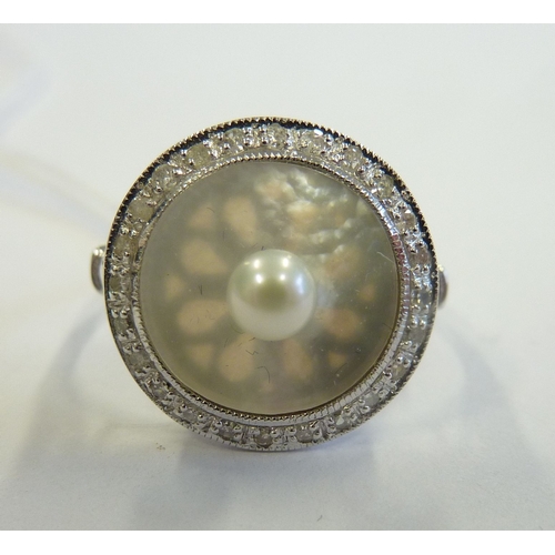 210 - An 18-carat white gold, mother of pearl and diamond ring