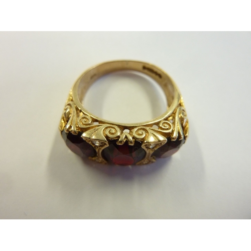 212 - A large boathead gold ring set with three large garnets