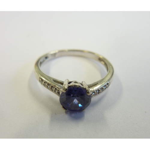 213 - A 9-carat white gold and sapphire ring with diamond shoulders