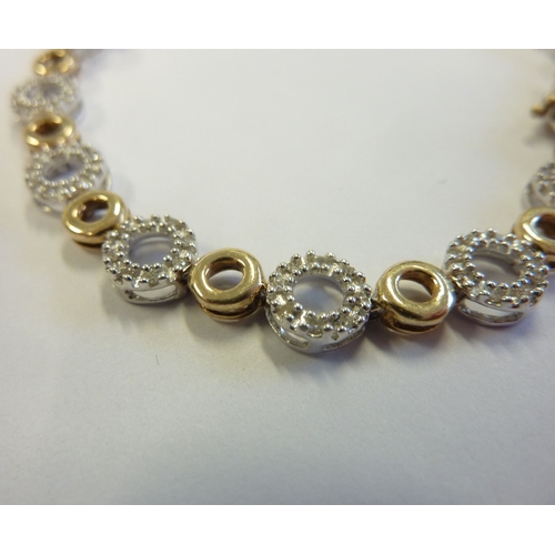 216 - A two-colour 9-carat gold bracelet set with 180 diamonds