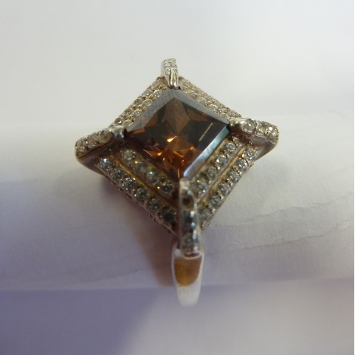 219 - A ladies boxed ring, hallmarked silver and centrally set with a lozenge shaped hand cut stone surrou... 