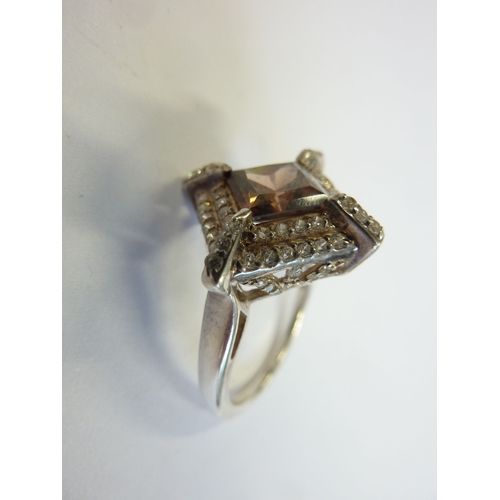 219 - A ladies boxed ring, hallmarked silver and centrally set with a lozenge shaped hand cut stone surrou... 